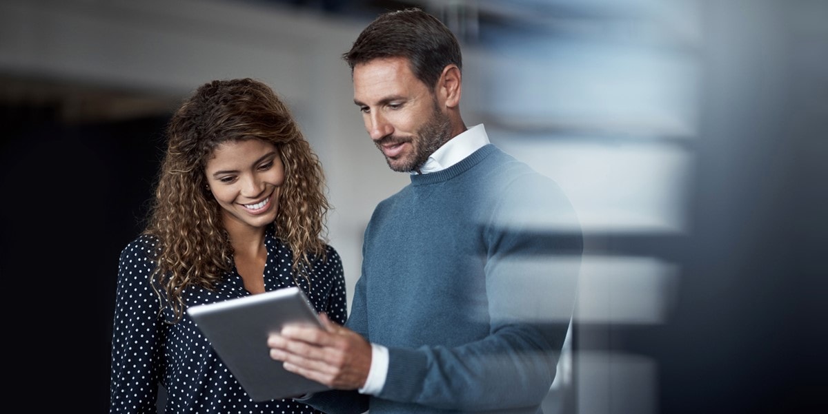 two people in the office reviewing document