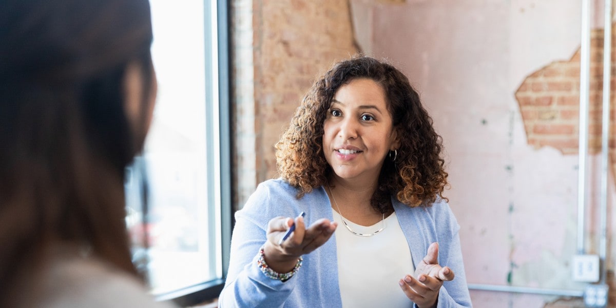 woman in office meeting with colleague