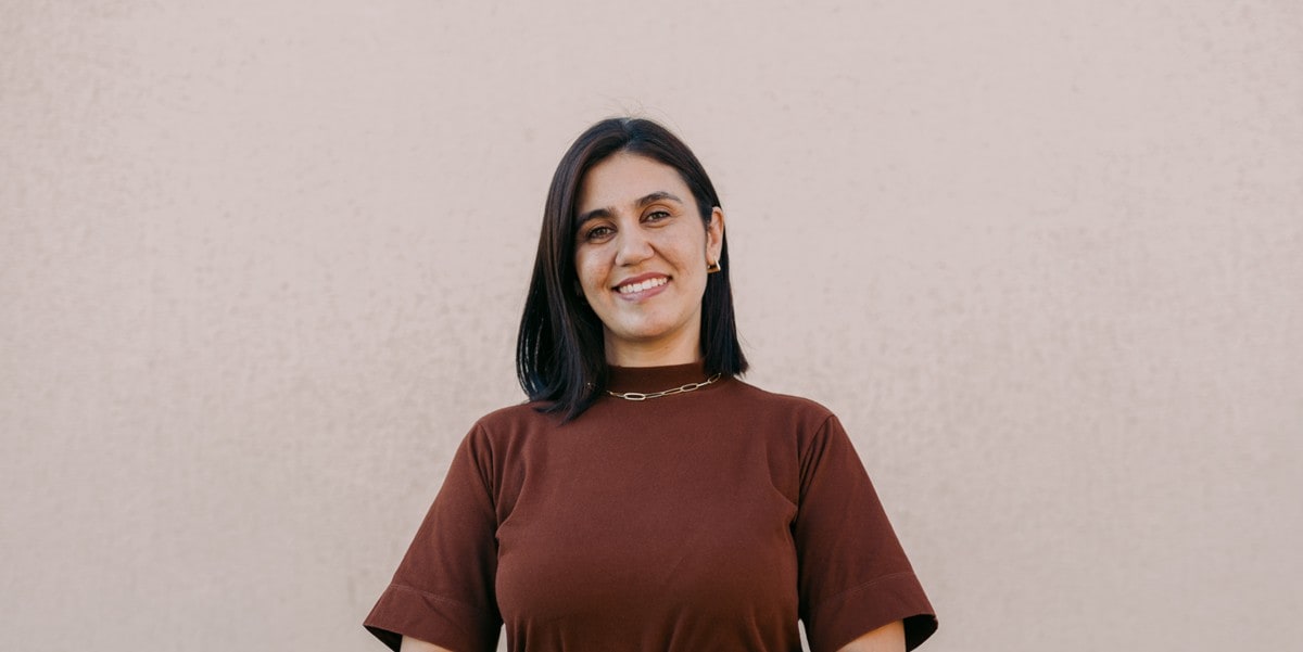 woman smiling with arms crossed
